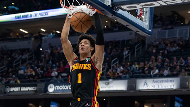 Jalen Johnson dunks the ball.